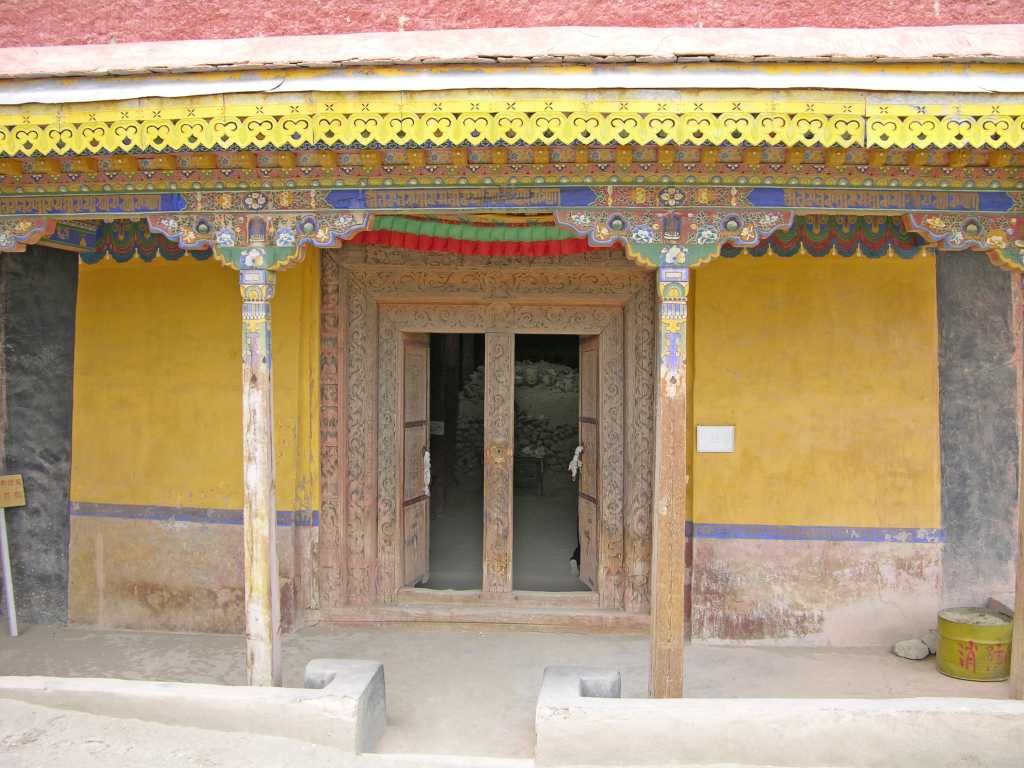 Tibet Guge 07 Tsaparang Red Temple 01 Outside Tsaparang�s Red Temple (Lhakhang Marpo) was built around 1470, perhaps 30 years earlier than the White Temple. The murals in this 16m x 20m chapel were repainted around 1630, shortly before the fall of the Guge kingdom. The main statue of Shakyamuni was built of gilded bronze, but alas lays in rubble, destroyed by the Chinese Red Guards.